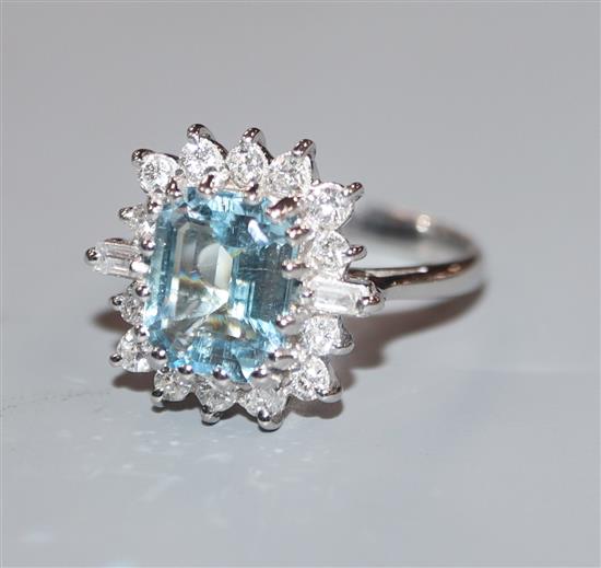 A modern 18ct white metal, aquamarine, baguette and round cut diamond set cluster ring, size K/L.